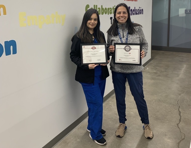 Two nurses from Congreso Health Center holding their certificates.